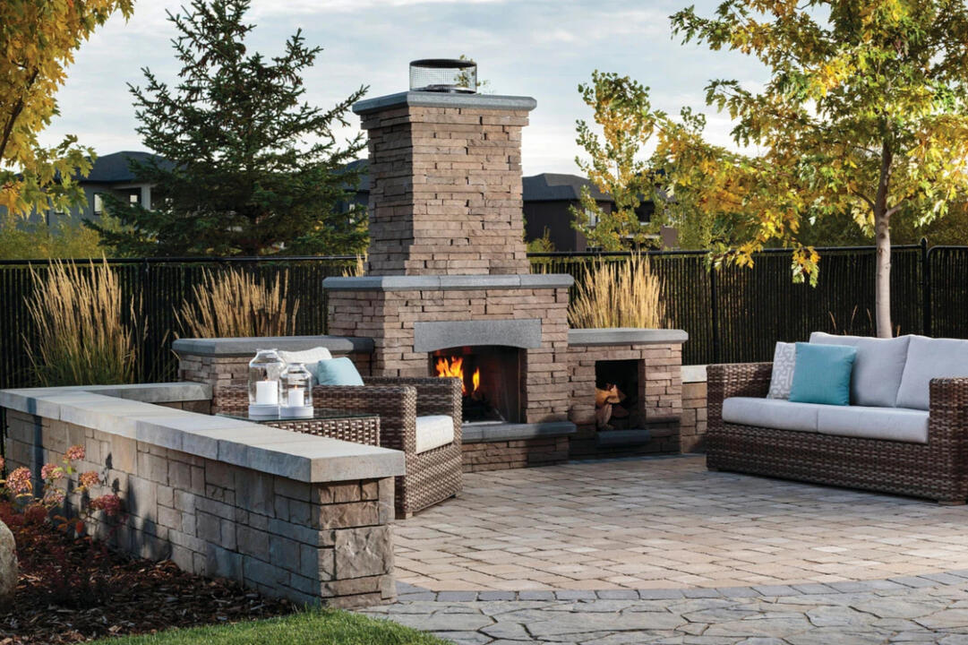 Belgard outdoor fireplace with paver patio and sitting wall in Mequon, WI. Customizable outdoor living space with multiple color and design options.